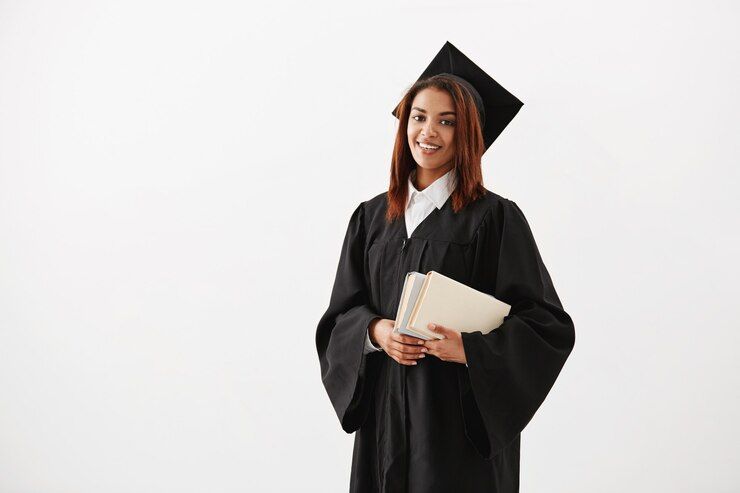 beautiful-cheerful-african-female-graduate-smiling-holding-books-copy-space_176420-14337.jpg