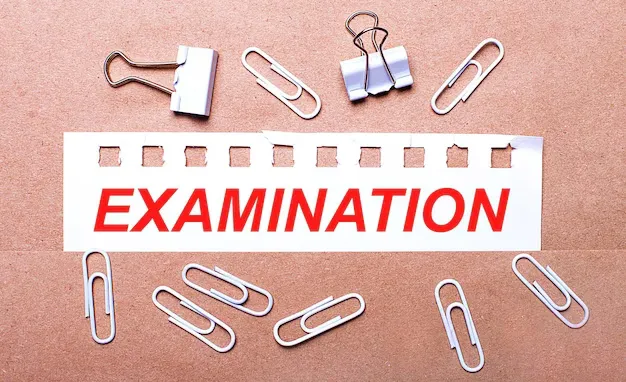 brown-background-white-paper-clips-torn-strip-white-paper-with-text-examination_380694-8485.webp