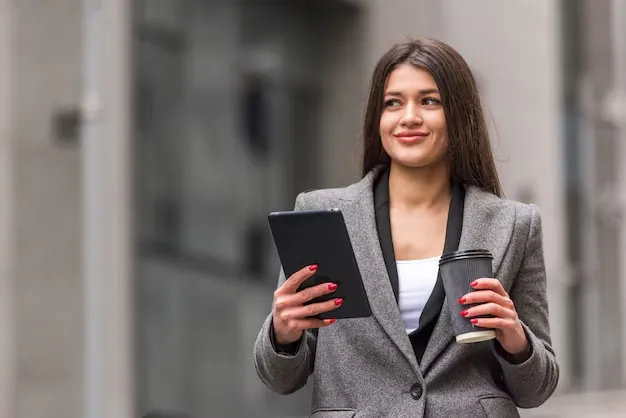 brunette-businesswoman-using-her-tablet_23-2148142847 (1) (1).webp