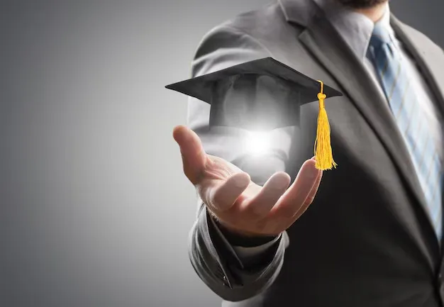 business-man-is-holding-graduation-hat-business-education-concept_488220-74334.webp