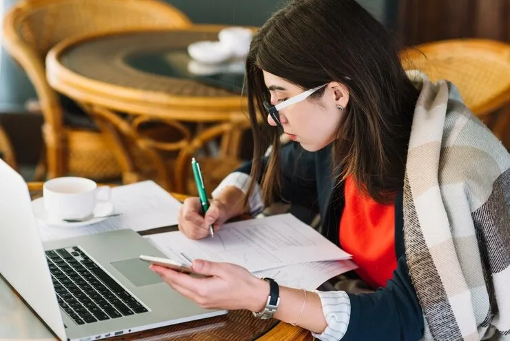 businesswoman-using-laptop-coffee-shop_23-2148002144 (1).webp