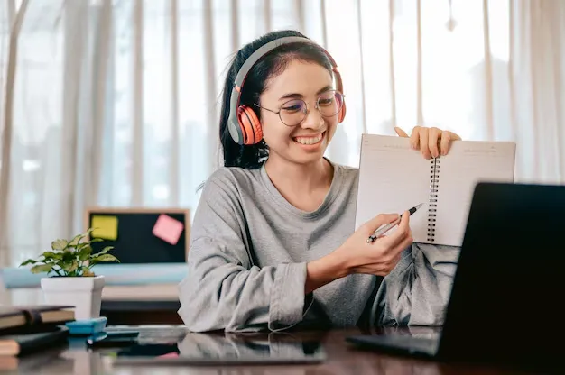 businesswomen-is-using-notebook-computers-wear-headphones-online-meetings-working_532405-302.webp