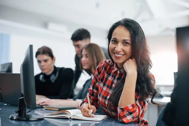 cheerful-brunette-group-young-people-casual-clothes-working-modern-office_146671-16448.webp
