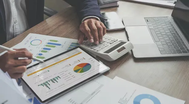 close-up-businessman-partner-using-calculator-ldigital-tablet-calaulating-finance-tax-accounting-statistics-analytic-research-concept_1077198-7380.webp