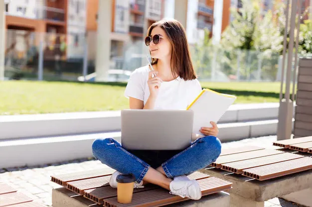confident-attractive-woman-sitting-bench-park-messaging-social-media-while-writing-notebook-coffee-break_231208-853.webp