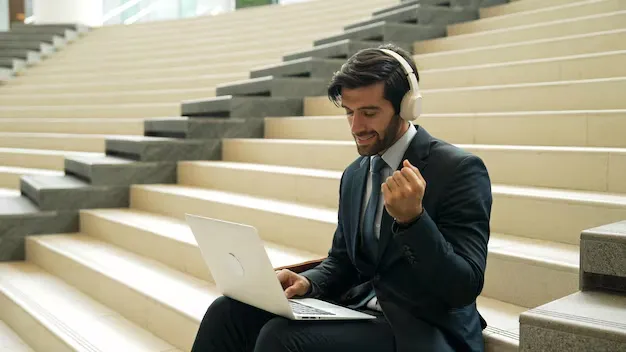 confident-business-man-celebrate-successful-idea-while-listen-music-exultant_31965-504315.webp