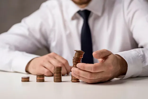 front-view-businessman-with-coins_23-2148569071.webp