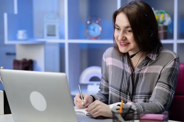 girl-student-wear-headphone-study-online-with-internet-teacher-learn-language-talk-looking-laptop-focused-young-woman-make-video-call-tutoring-write-notes_153228-790.webp