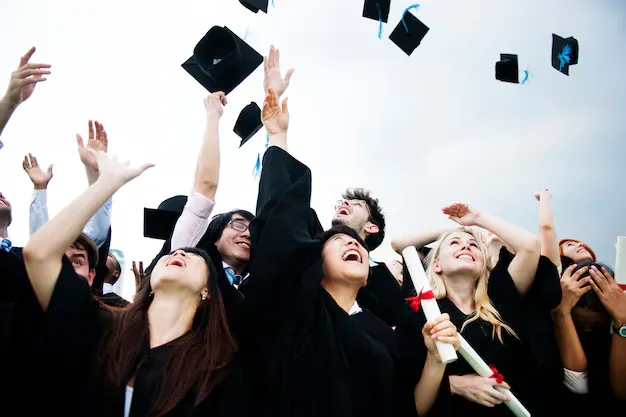 group-diverse-grads-throwing-caps-up-sky_53876-56031 (1) (1).webp