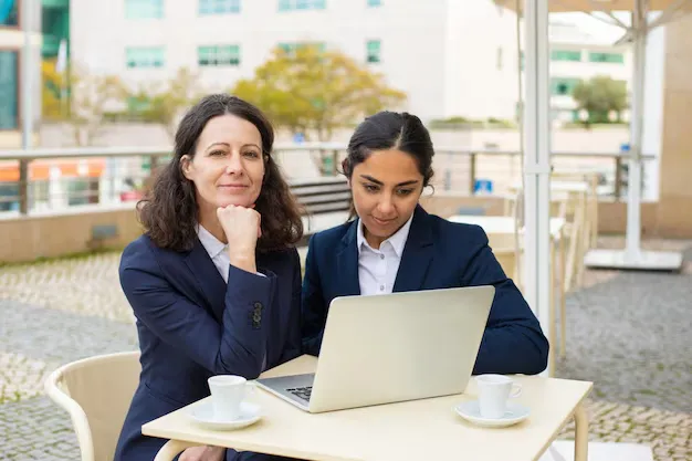 happy-businesswomen-with-laptop-outdoor-cafe_74855-5077 (2).webp