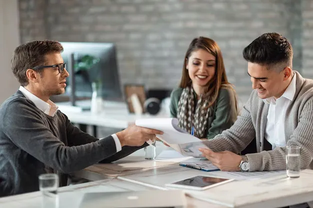 happy-couple-signing-contract-meeting-with-their-real-estate-agent-office_637285-868.webp