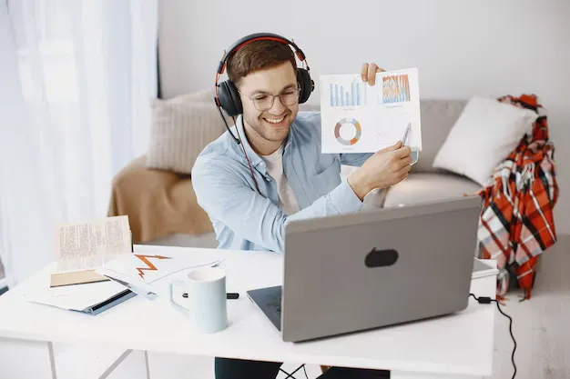 man-sitting-living-room-home-guy-enjoying-studying-using-laptop-headset_1157-48714.webp