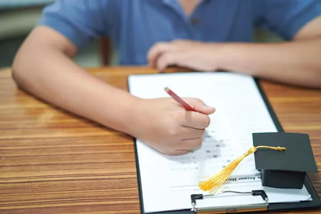 midsection-student-studying-with-mortarboard-desk_1048944-2264246.webp