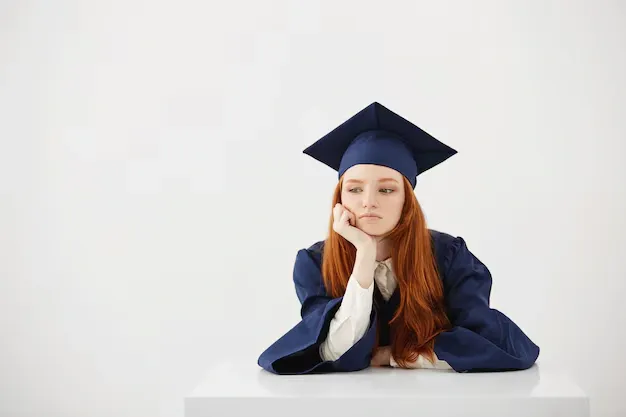 redhead-female-graduate-mantle-thinking-sitting_176420-14247 (1).webp