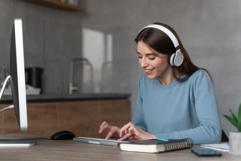 side-view-woman-working-media-field-with-computer-headphones_23-2148901113.jpg