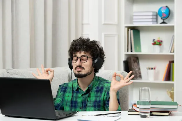 student-online-cute-young-guy-studying-computer-glasses-green-shirt-showing-zen-sign_140725-164678.webp