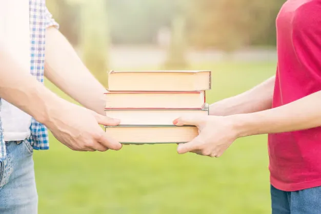 students-holding-books-park_23-2148199218.webp