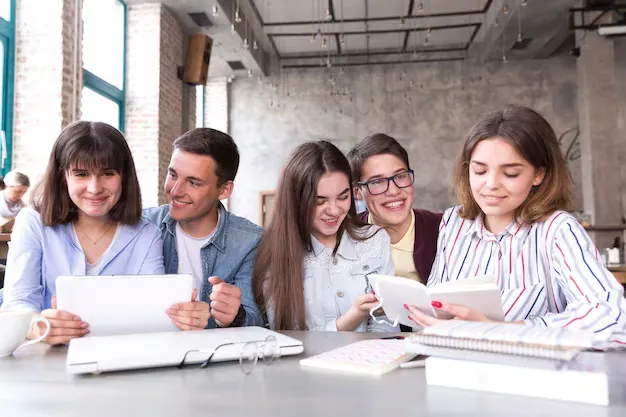 students-sitting-table-studying-with-books-tablet_23-2148166397.webp