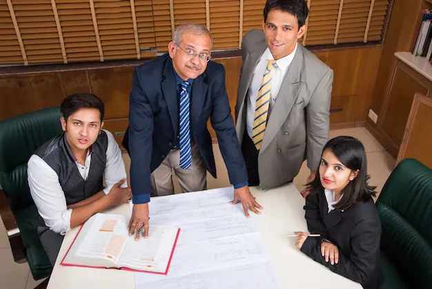 team-indian-architects-builders-drafting-discussing-housing-project-with-building-model-plan-around-conference-table-selective-focus_466689-15336.webp