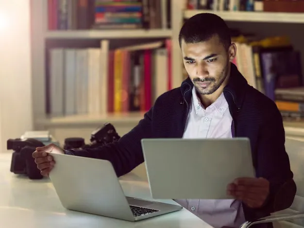 technology-helps-him-work-smarter-shot-focused-young-photographer-working-laptop-digital-tablet-his-home-office-early-evening_590464-36512.webp