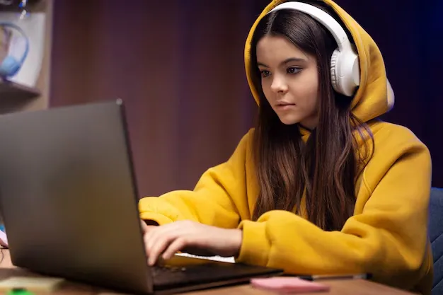 teenage-girl-using-laptop-home_23-2149332882.webp