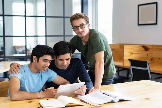 three-positive-students-browsing-tablet-computer-together_1262-15303.webp