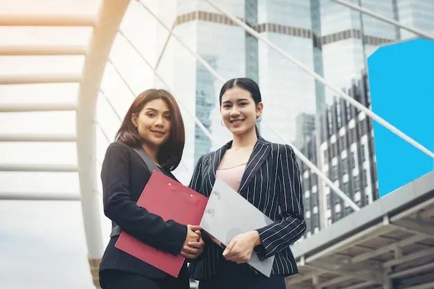 two-business-woman-standing-discussing-front-office-business-working-concept_1150-2411.webp
