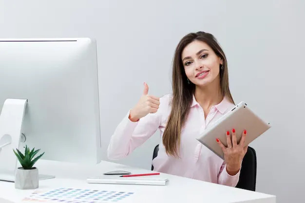 woman-desk-giving-thumbs-up-while-holding-tablet_23-2148434684.webp