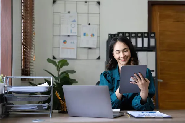 young-asian-businesswoman-works-tablet-with-laptop-office_1077198-7832.webp