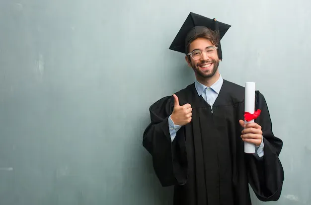 young-graduated-man-against-grunge-wall-with-copy-space-cheerful-excited_1187-15513.webp