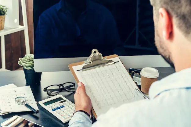 young-man-businessman-sitting-his-working-table-office_93675-52798.webp