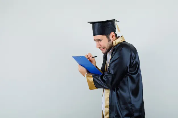 young-man-graduate-uniform-taking-notes-clipboard-looking-mournful_176474-57956.webp